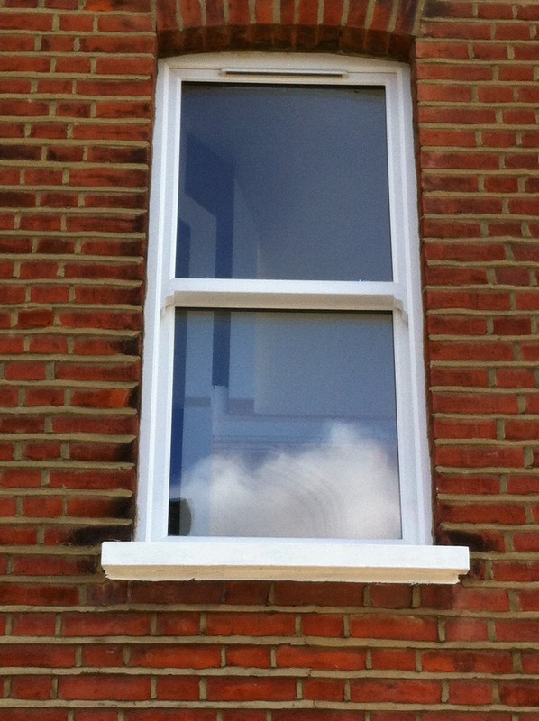 uPVC sash window on Victorian red brick house in Staines-upon-Thames